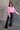 Full body front view of model wearing the Catherine Pink Heathered Mock Neck Sweater that has pink and white heather knit fabric, ribbed hem, a high neck, and long balloon sleeves with cuffs.