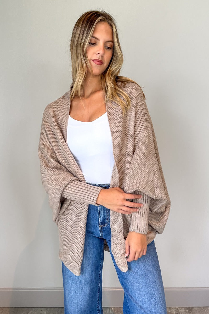 Front view of model wearing the Jennifer Mocha Knit Long Sleeve Open Cardigan which features light mocha knit fabric, front open with no closure, ribbed hem details and long sleeves with cuffs.