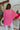 Back view of model wearing the Take My Hand Sweater that has hot pink loose-knit fabric, a high-low hem, a round neck, and 3/4 batwing sleeves with cuffs