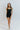 Full body front view of model wearing the Can You Keep Up Bodysuit that features black stretch fabric, a round neckline, adjustable thick straps, and fitted shorts.