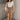 Full body view of model wearing the Journey Mocha Brown Cargo Mini Skirt which features taupe brown textured soft fabric, two fornt cargo pocket with zipper closure, elastic waistband with tie and mini length.