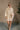 full body front view of model wearing the Isabella Cream Turtleneck Sweater Dress that has cream cable knit fabric, ribbed trim, mini length, a turtleneck, dropped shoulders, and long balloon sleeves with ribbed cuffs.
