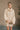 front view of model wearing the Isabella Cream Turtleneck Sweater Dress that has cream cable knit fabric, ribbed trim, mini length, a turtleneck, dropped shoulders, and long balloon sleeves with ribbed cuffs.