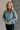 Front view of model wearing the Parker Sea Foam Textured Knit Long Sleeve Sweater which features seafoam textured knit fabric, ribbed hem, round neckline, dropped shoulders and long balloon sleves with cuffs.