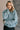 Front view of model wearing the Parker Sea Foam Textured Knit Long Sleeve Sweater which features seafoam textured knit fabric, ribbed hem, round neckline, dropped shoulders and long balloon sleves with cuffs.