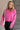 Front view of model wearing the Clara Fuchsia Knit Button Snap Up Long Sleeve Sweater which features hot pink knit fabric, cropped waist, button snap up closure, collared neckline and long sleeves with cuffs.