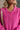 Close up view of model wearing the Clara Fuchsia Knit Button Snap Up Long Sleeve Sweater which features hot pink knit fabric, cropped waist, button snap up closure, collared neckline and long sleeves with cuffs.