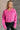 Front view of model wearing the Clara Fuchsia Knit Button Snap Up Long Sleeve Sweater which features hot pink knit fabric, cropped waist, button snap up closure, collared neckline and long sleeves with cuffs.