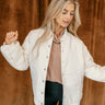 Front view of model wearing The Katherine White Snap Up Jacket features cream lightweight fabric, two front slit pockets, ribbed hem, silver button snaps front closure, ribbed round neckline and long sleeves with a monochrome swirl design and ribbed cuffs