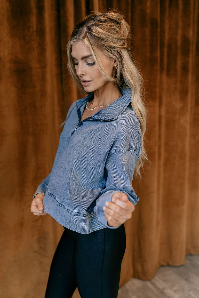 Front view of model wearing The Mandy Denim Quarter Zip Pullover features denim blue fabric, thick hem, quarter zip up with adjustable high neckline and long sleeve with cuffs.