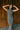 front view of model wearing the Alianna Silver Shimmer Cowl Neck Midi Dress that has grey and silver shimmer fabric, midi length, ruched side details, a slit on the side, a slight cowl high neckline, and a sleeveless design.