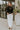 Full body front view of model wearing the Abby Black Lace Long Sleeve Top that has black sheer fabric, monochrome lace floral pattern, lettuce hem details, a high neck and long sleeves.