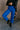 front view of model wearing the Kyla Royal Parachute Cargo Pants that have dark royal breathable nylon fabric, pockets, an elastic waist with a bungee, and relaxed legs with elastic ankles and bungees.