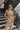 Front view of model wearing the Now Or Never Dress that has mocha ribbed fabric, a mini-length hem, a scoop neckline, adjustable double spaghetti straps, and a built-in bra