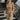 Front view of model wearing the Now Or Never Dress that has mocha ribbed fabric, a mini-length hem, a scoop neckline, adjustable double spaghetti straps, and a built-in bra