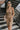 Front view of model wearing the Now Or Never Dress that has mocha ribbed fabric, a mini-length hem, a scoop neckline, adjustable double spaghetti straps, and a built-in bra