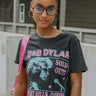 Front view of model wearing the Bob Dylan Cropped Graphic Tee, which features charcoal knit fabric, a round neckline, and short sleeves.