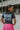 Back view of model wearing the Bob Dylan Cropped Graphic Tee, which features charcoal knit fabric, a round neckline, and short sleeves.