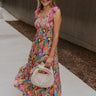 Full body view of female model wearing the McKenzie Pink Multi Tie Straps Midi Dress which features Pink Multi Abstract Print, Smocked Upper, Midi Dress and Pink Tie Straps