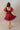 Back view of model wearing the Willow Burgundy Puff Sleeve Dress that has burgundy fabric, mini length, a tiered skirt, smocked chest, a square neck and short puff sleeves