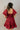 Back view of model wearing the Willow Burgundy Puff Sleeve Dress that has burgundy fabric, mini length, a tiered skirt, smocked chest, a square neck and short puff sleeves