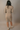 Full body back view of model wearing the Adeline Khaki Ribbed Long Sleeve Midi Dress which features khaki ribbed fabric, midi length, slits on each side, a square neckline, and long sleeves.