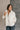  front view of model wearing the view of model wearing the Piper Off White Sherpa & Corduroy Jacket that has sherpa fabric, corduroy details, front snaps with a zipper, a high neck, pockets, and long sleeves.
