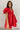 Front view of model wearing the Sophia Red Satin Short Puff Sleeves Mini Dress which features red satin fabric, mini length, plunge neckline, elastic wiastband, short puff sleeves and open back with pearl button closure.