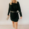 Full body front view of model wearing the Sara Black Long Sleeve T-shirt Dress that has black cotton fabric, mini length, slits on each side, a round neckline, dropped shoulders, and long sleeves.