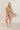 Full body front view of model wearing the Rosalie Cream Floral Long Sleeve Mini Dress that has cream lightweight fabric with a green and mustard floral print, a smocked upper, a plunge neck, and long puff sleeves.