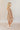 Full body side view of model wearing the Rosalie Cream Floral Long Sleeve Mini Dress that has cream lightweight fabric with a green and mustard floral print, a smocked upper, a plunge neck, and long puff sleeves.