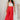 Full body view of model wearing the Scarlett Red Wide Leg Pants which features red lightweight fabric, two front pockets, a front zipper with a hook closure, belt loops and wide legs.