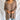 Front view of model wearing the Easy Breezy Top, that has a mocha colored knit material, an open knit design, a V neckline, a long cuffed sleeve, side slits, and a high-low design.