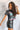 Side view of model wearing the Bob Dylan Cropped Graphic Tee, which features charcoal knit fabric, a round neckline, and short sleeves.