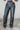 Front view of model wearing the Alexis Black Faux Leather Pants which features black faux leather, front zipper with button closure, two front pockets, two back pockets, belt loops and wide pant legs.