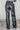 Back view of model wearing the Alexis Black Faux Leather Pants which features black faux leather, front zipper with button closure, two front pockets, two back pockets, belt loops and wide pant legs.