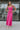 Full body front view of model wearing the Coastal Paradise Dress in Pink that has hot pink ribbed fabric, midi length, a round neckline, an elastic waistband, and spaghetti straps