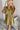 Frontal view of the Meet Your Match Dress that features a green colored material, a collar neckline, a button-up front, a ruffle sleeve, side pockets, and a mini length.