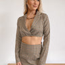 Frontal view of the It Takes Two Crop Blazer that features a beige colored tweed material, a brown and black gingham print, a collar and lapel neckline, a long sleeve, and a cropped fit.