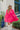 Frontal view of the Wide Open Spaces Mini Dress that features a hot pink material, a round neck with a ruffle trim, a 3/4 button-up front, a long sleeve, a tiered babydoll design, and a flowy fit.