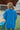 Back view of the Beach Dreams Oversized Top that features a hidden button up front with a collar, 3/4 length batwing sleeves, and a flowy fit with a high-low hemline.