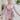 Frontal view of the Risk It All Dress that features a dusty pink silk material, a collar neck, a V surplice neckline, a long cuffed sleeve, a wrap front with a tie detail, and a mini length.