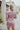 Back view of the Risk It All Dress that features a dusty pink silk material, a collar neck, a V surplice neckline, a long cuffed sleeve, a wrap front with a tie detail, and a mini length.