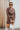 Frontal view of the Next Century Dress that features a brown tweed material, a navy gingham print, a lapel surplice neckline, a long sleeve, a wrap front with a tortoiseshell buckle, and a mini length.
