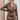 Frontal view of the Next Century Dress that features a brown tweed material, a navy gingham print, a lapel surplice neckline, a long sleeve, a wrap front with a tortoiseshell buckle, and a mini length.
