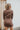 Back view of the Next Century Dress that features a brown tweed material, a navy gingham print, a lapel surplice neckline, a long sleeve, a wrap front with a tortoiseshell buckle, and a mini length.
