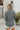 Back view of the Around The Block Top that features a navy chiffon material, a taupe and green geometric print, a collar neckline, a button-up front, and a long sleeve.