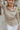 Frontal view of the Remember Me Top that features a taupe chiffon material, an ivory and yellow geometric print, a collar neckline, a button-up front, and a long sleeve.