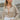 Frontal view of the Remember Me Top that features a taupe chiffon material, an ivory and yellow geometric print, a collar neckline, a button-up front, and a long sleeve.