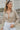 Frontal view of the Remember Me Top that features a taupe chiffon material, an ivory and yellow geometric print, a collar neckline, a button-up front, and a long sleeve.